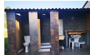 a bathroom with a shower and a toilet and a desk at tente pour 2 personnes in Saint-Jean-de-Monts