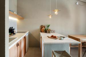 a kitchen with a island in the middle of a room at Baia Dorata beach apartments in Porto Istana