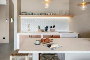 a kitchen with a table with a plate of bread at Baia Dorata beach apartments in Porto Istana