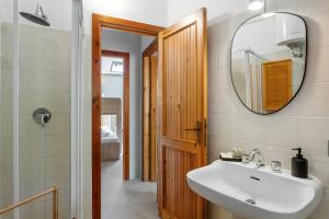 a bathroom with a sink and a mirror at Baia Dorata beach apartments in Porto Istana