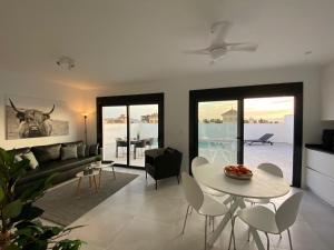 a living room with a white table and chairs at Villa Nikki-Adore in Mazarrón