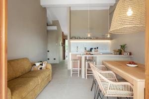 a living room and kitchen with a couch and a table at Baia Dorata beach apartments in Porto Istana