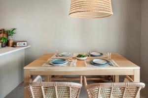 a dining room table with chairs and a tableablish at Baia Dorata beach apartments in Porto Istana