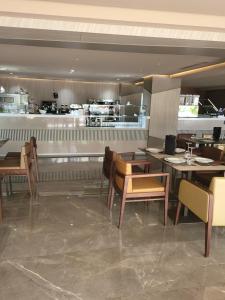 a restaurant with tables and chairs and a counter at Hotel Appartement Tanger in Tangier