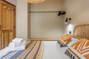 a bedroom with two beds and a door at Baia Dorata beach apartments in Porto Istana