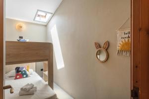 a small bedroom with a bed and a mirror at Baia Dorata beach apartments in Porto Istana