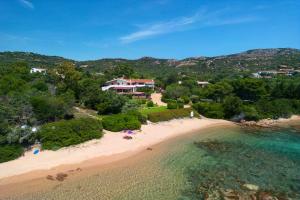 an aerial view of a beach with a resort at Baia Dorata beach apartments in Porto Istana