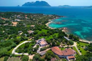 an aerial view of a house next to the ocean at Baia Dorata beach apartments in Porto Istana