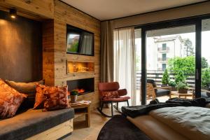 a living room with a couch and a fireplace at Araldo Eco-Lodge in Bosco Chiesanuova