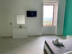 a white room with a bed and a window at La Dolce Vita in Camerota