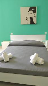 a bed with two pillows on top of it at La Dolce Vita in Camerota