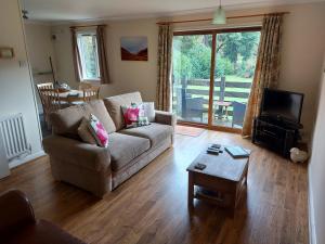 a living room with a couch and a table at The Chalets in Eskdale