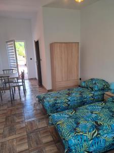 a living room with a bed and a table and chairs at Noclegi u Wandy in Ropienka