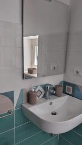 a bathroom with a white sink and a mirror at La Dolce Vita in Camerota
