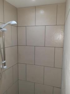 a bathroom with a shower with white tile at Southbay Room 2 in Bridlington