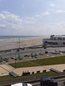 a view of a beach with a building and a parking lot at Southbay Room 2 in Bridlington