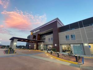 a building with a empty parking lot in front of it at La Quinta Inn & Suites by Wyndham Yucaipa in Yucaipa