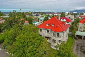 a large white building with a red roof at Bright apartment near city center in Reykjavík