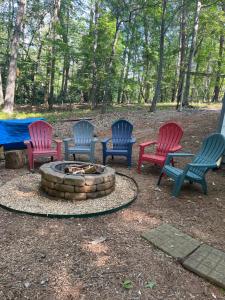 a group of chairs sitting around a fire pit at The Grindle Bridge Cabin in Dahlonega