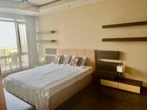 a bedroom with a bed and a large window at Vista Sul Mare II in Burgas City
