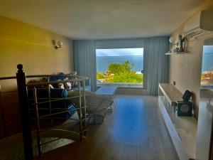 a bedroom with a bunk bed with a view of the ocean at Vista Sul Mare II in Burgas
