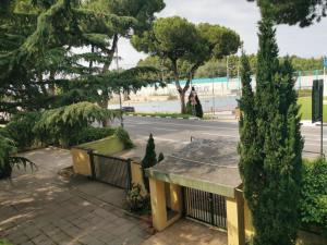 a view of a street with trees and a building at L'Anfora in Montesilvano