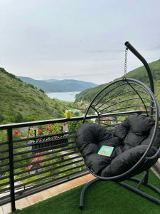 a swing sitting on top of a balcony at Domini LakeView Apartment in Mavrovo