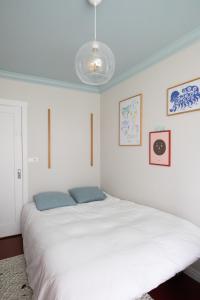 a bedroom with a large white bed with blue pillows at 2bedroom apartment close to centre in Reykjavík