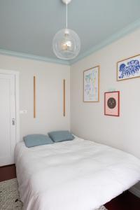 a bedroom with a large white bed with blue pillows at Bright apartment near city center in Reykjavík