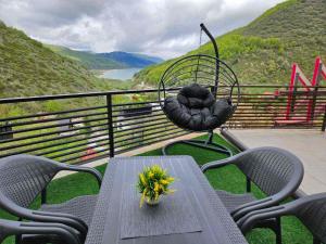 a table and chairs on a balcony with a view at Domini LakeView Apartment in Mavrovo