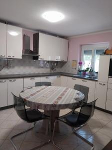 a kitchen with a table and chairs in it at Apartma Mira in Zgornje Škofije