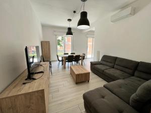 a living room with a couch and a table at I lecci in Livorno