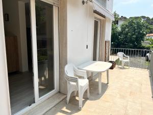 a white table and chairs on a patio at I lecci in Livorno