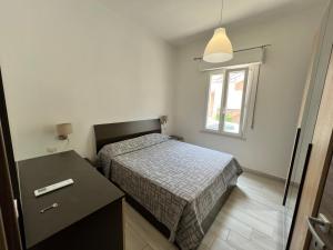 a small bedroom with a bed and a window at I lecci in Livorno
