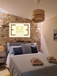 a bedroom with a bed with two towels on it at ESSE boutique homes in Cefalù