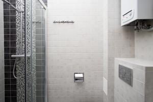 a bathroom with a shower with a toilet and a sink at Studio Świętojańska in Gdynia