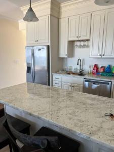 a kitchen with a granite counter top and a refrigerator at Hampton Beach OCEAN FRONT Condo at the Surf in Hampton