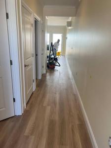 a hallway of an apartment with a man working at Hampton Beach OCEAN FRONT Condo at the Surf in Hampton