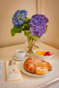 a table with a plate of bread and flowers at Hotel Belvedere in Forte dei Marmi