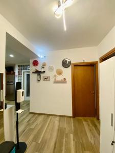 a living room with a ceiling fan and a wooden floor at Venice Mestre Station House in Mestre