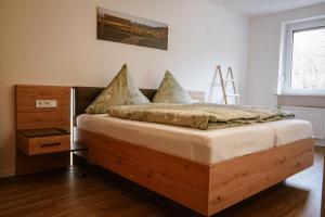 a bedroom with a wooden bed in a room at Ferienwohnung Bergzeit in Oy-Mittelberg