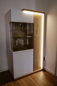 a refrigerator with a glass door in a room at Ferienwohnung Bergzeit in Oy-Mittelberg
