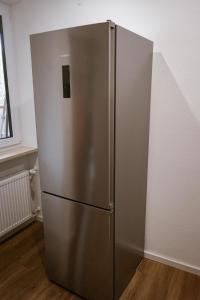 a stainless steel refrigerator in the corner of a room at Ferienwohnung Bergzeit in Oy-Mittelberg