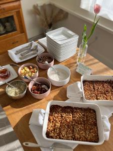 a wooden table with several dishes of food on it at The August House in Windsor