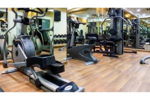 a gym with treadmills and elliptical machines at Capital O 126 Manama Tower Hotel in Manama