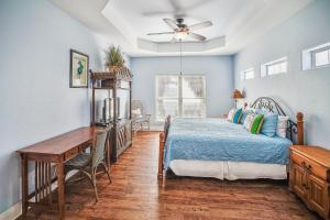 a bedroom with a bed and a desk at Villa Laguna! STEPS to the pool & lagoon views, with boardwalk to beach in Port Aransas