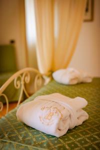 uma toalha sentada em cima de uma cama em Hotel Belvedere em Forte dei Marmi