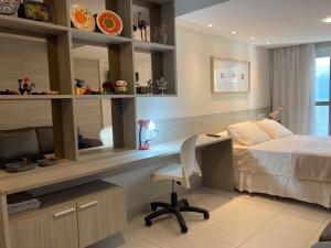 a bedroom with a bed and a desk and a bed and a desk at BCE Home Stay in Recife