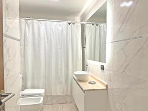 Un baño con lavabo, inodoro y ducha. en Parque Pueyrredon IV, en Mendoza 14 fotos más