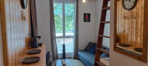 a room with a room with a window and a couch at Studio Gare&centre de Grenoble in Grenoble